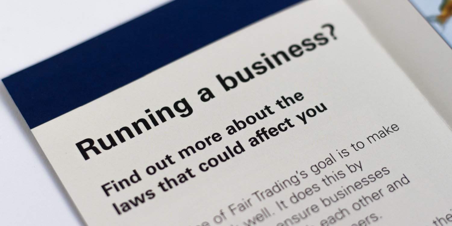 A leaflet lying on a table with the headline 'Running a business?' and a sub-heading of 'Find out more about the laws that could affect you'.